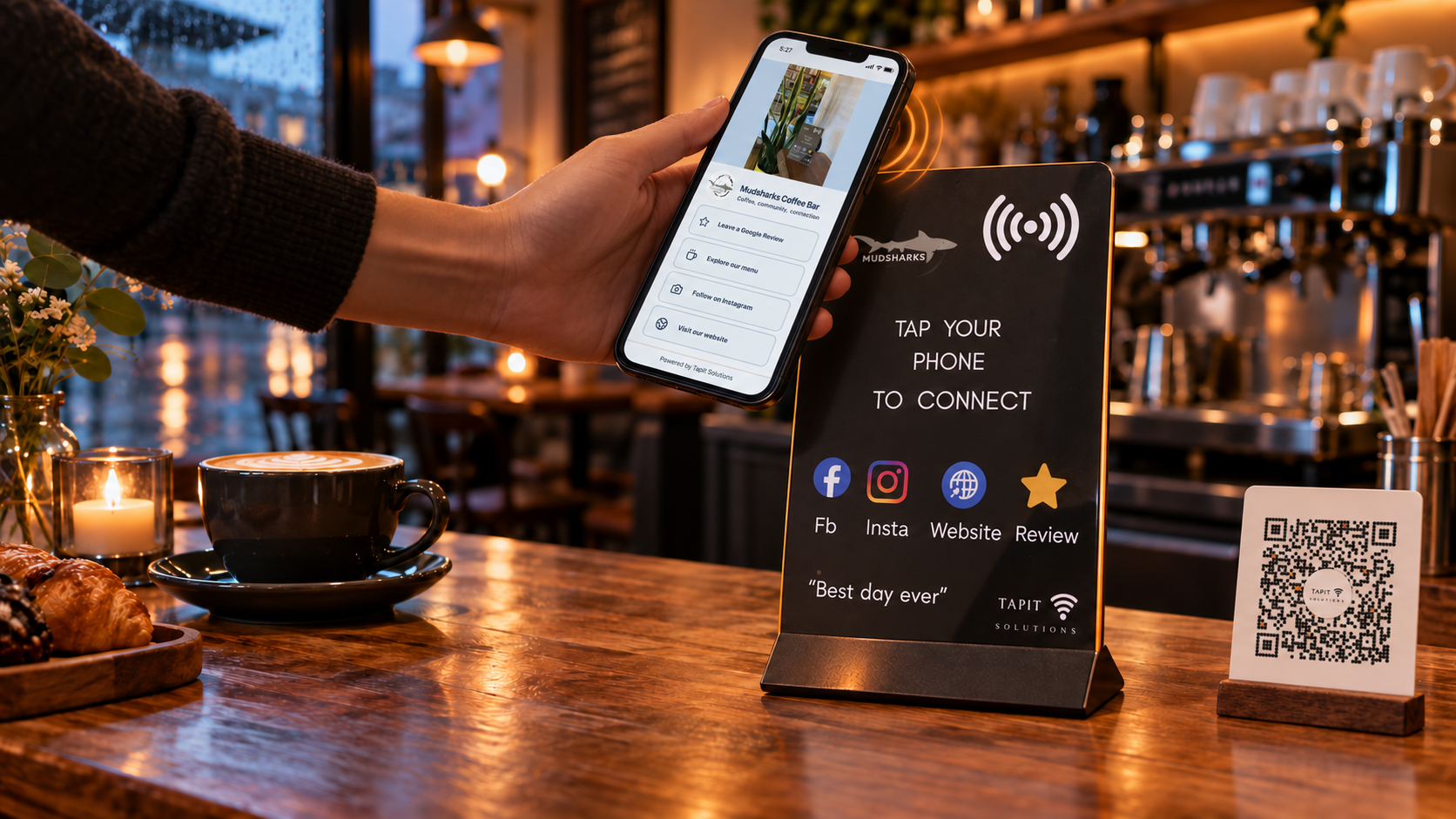 A Mudsharks TapIt stand with a customer page open on a phone.